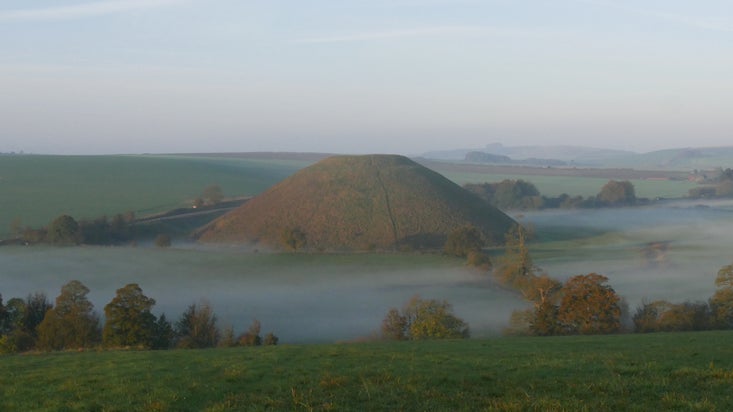A lake of mist surrounding Silbury Hill on an autumn morning at Avebury, Wiltshire. Silbury Hill is managed by English Heritage.